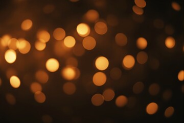 Abstract golden bokeh lights on a dark background creating a warm glowing effect.