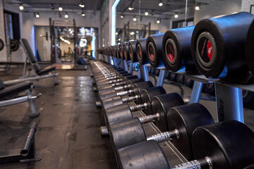 A dumbbell rack for bodybuilding. Working with free weight.