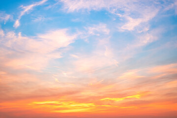 Obraz premium Sky,sunset, beautiful , luxury soft gradient orange gold clouds and sunlight on the blue sky perfect for the background, Sunrise on morning or everning in winter warm time ,Twilight summer,silhouette