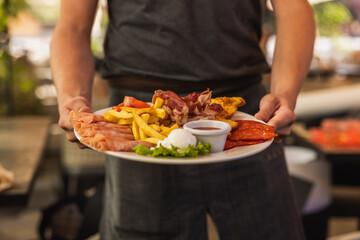 Chef Serving Delicious Breakfast Platter with Eggs and Bacon