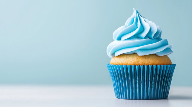 Delicious cupcake with blue frosting on a light background, perfect for sweet treats.
