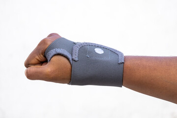 Female hand with a wrist brace and thumb, isolated on a white background. This wrist support is suitable for both hands and both men and women.