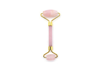 Pink Gua Sha stone roller on white background. Top view. Flat lay.