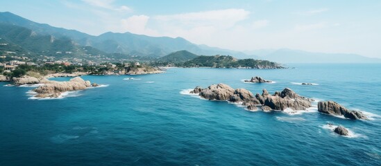 Obraz premium Aerial View of Coastal Rocks and Mountains in Italy