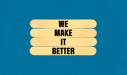 We Make It Better Symbol. Concept word We Make It Better on beautiful wooden stick. Beautiful Blue Chart Paper Background. Business and We Make It Better concept. Copy space