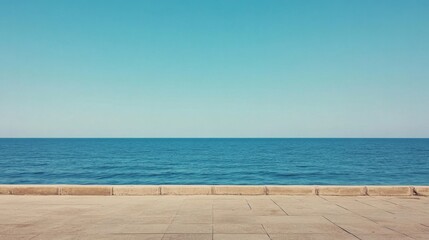 Fototapeta premium Serene coastal view with clear blue sky and calm ocean waves, perfect for relaxation and inspiration
