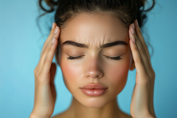 Fototapeta premium Young woman suffering from headache massaging temples. Girl with migraine or stress, tired female with throbbing pain