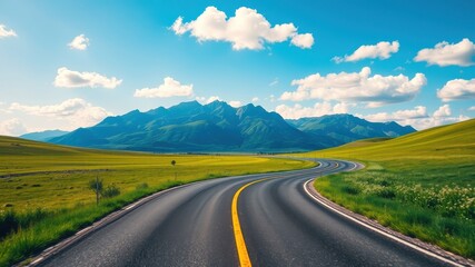 Asphalt road winding through vibrant green fields towards majestic mountains under a bright summer sky