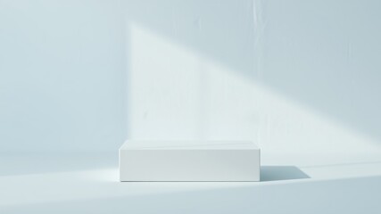 Obraz premium A simple white rectangular platform sits in a light blue room, bathed in soft sunlight