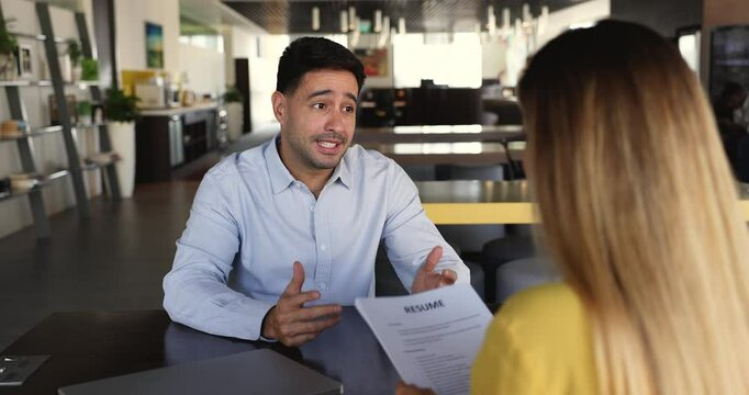 Woman HR manager interviewing young Hispanic male, hiring applicant shake hands, finish job interview successfully, feel satisfied with candidature qualification, education and competence. Recruitment