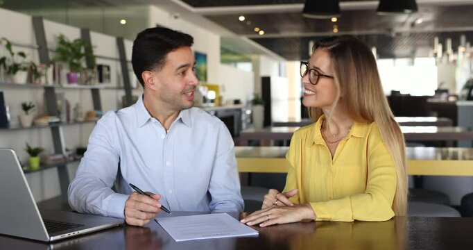 Female bank financial advisor explains terms and conditions of legal paper agreement to male client, make deal, shake hands after signing contract. Establish partnership, company services acquisition