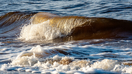 beautiful waves crashing against the seashore, windy day on the rocky shore of Vidzeme, Baltic Sea