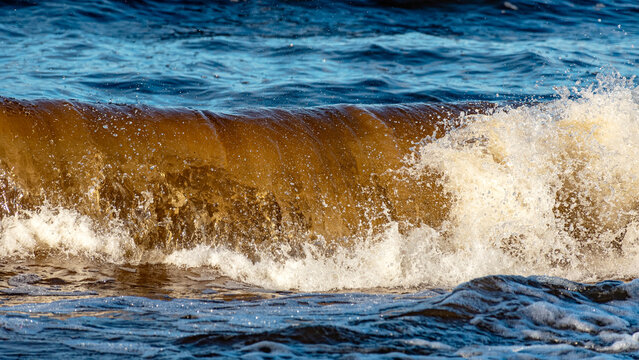 beautiful waves crashing against the seashore, windy day on the rocky shore of Vidzeme, Baltic Sea