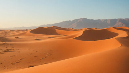Vast desert landscape with golden sand dunes and distant mountains under clear blue sky