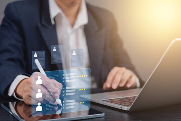 Businessman using a tablet to manage digital profiles and performance reviews.HR management online employee assessment, and professional insights, recruitment.