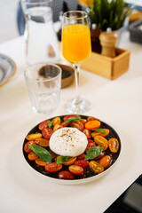 Burrata with cherry tomatoes and fresh basil