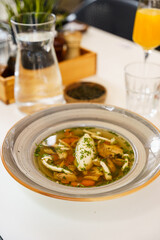 Clear chicken broth with vegetables and dumpling