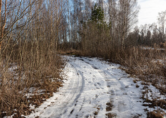 a muddy, wet road, mud texture, snow remnants, winter road