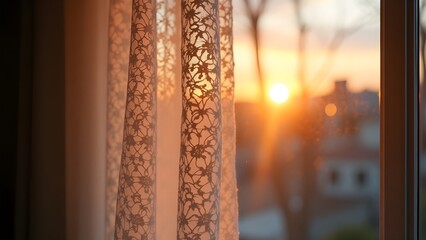 A retro lace curtain with a glowing sunset outside the window