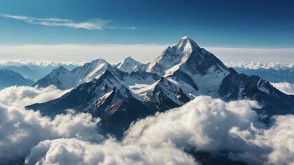 Breathtaking View of Snow-Capped Mountain Peaks Emerging from the Wispy Clouds Beneath a Bright Blue