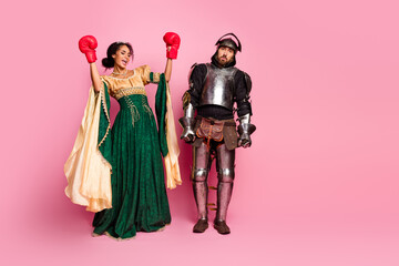 Playful Medieval Knight and Elegant Queen Stand Together on Vibrant Pink Backdrop