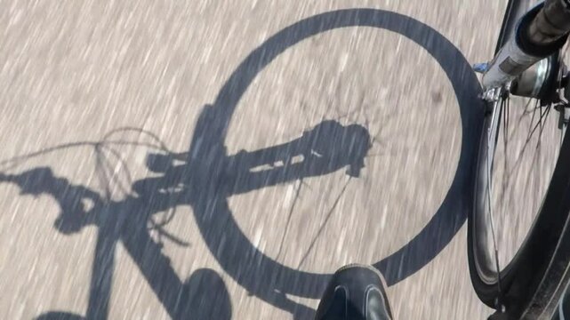 Shadow of a cyclist cycling along a cycle path in Noord Holland