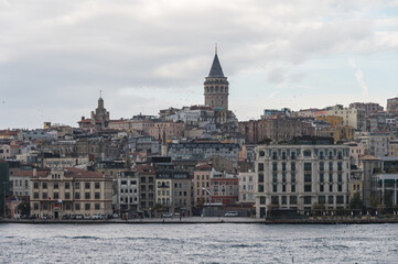 Fototapeta premium View of the Galata Tower, Beyoglu district, Istanbul, Turkey. 14th-century city landmark. Golden horn urban waterway