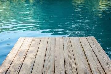 A wooden pier extending into a tranquil lagoon with faint ripples. picture
