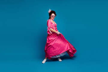 Full length photo of carefree pretty lady dressed pompous rococo costume dancing empty space...