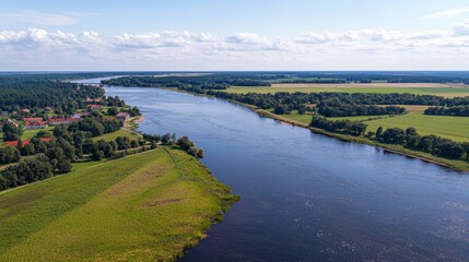 Obraz premium Aerial view River flowing through farmland, village, sunny day
