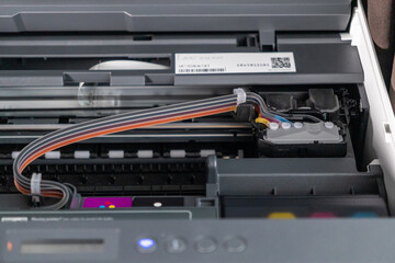 internal view of modern printer showing ink tubes and cartridge system with detailed components