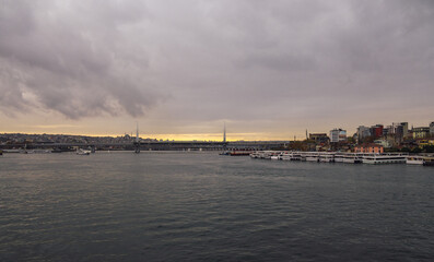 Sunset view of Halic Metro Bridge and cityscape of Istanbul with cloudy sky. Istanbul Turkiye