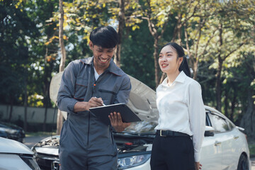 Car Repair Consultation: A friendly and professional male mechanic explains car repair details to a...