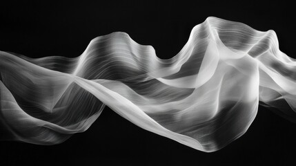 Fototapeta premium Black and white photograph of a wave-like structure. the wave appears to be made up of thin, wavy lines that create a sense of movement and depth.