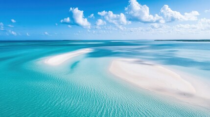 Obraz premium A stunning aerial view of a tropical island with pristine white sand beaches, turquoise waters, and a clear blue sky.
