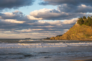 Stunning sunset view of Kumkoy beach. Black sea, amazing sky and boats in the distance. Turkey,...