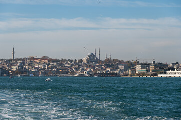 Fototapeta premium Panorama view from the deck of the ferry to the Bosphorus and Suleymanie Mosque. Sunny day and seagulls.