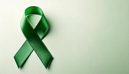 Close up photo of a green ribbon with plain color background