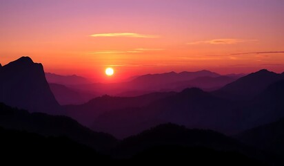 Obraz premium Vibrant sunset paints the sky with purple hues and an orange glow, silhouetting mountains in a panoramic, ethereal landscape. A breathtaking twilight scene of nature's serene beauty.