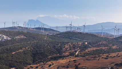 Wind turbines on a hillside, clean energy against a mountain backdrop. The Rock of Gibraltar on...