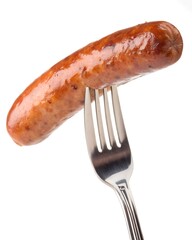 Grilled precook smoke beef sausage on a fork isolated on white background, clipping path
