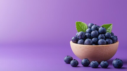 Wooden bowl filled with fresh blueberries and acai bowl berries on a purple background