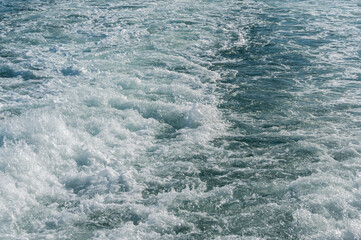 A trail of bubbling, foaming seawater from a ferry, Bosphorus, Turkey. Ocean weaves.
