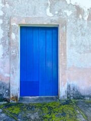 Vibrant Blue Door on Weathered Wall
