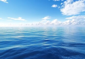 Fototapeta premium A vast expanse of blue ocean, with clear skies and clouds in the background.