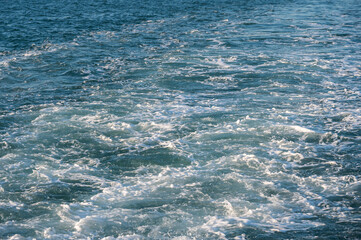 A trail of bubbling, foaming seawater from a ferry, Bosphorus, Turkey. Ocean weaves.