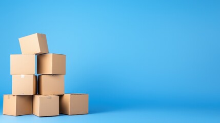 Obraz premium Stack of brown cardboard boxes arranged on a solid blue background for packaging or shipping concepts
