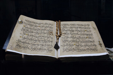 Large antique unique historical Quran on a black background. big religion book