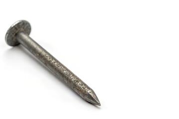 close-up view of a single metal nail with rough, tarnished surface and pointed tip, common hardware item for construction, carpentry, and fastening materials