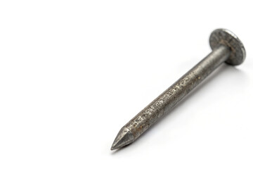 close-up view of a single metal nail with rough, tarnished surface and pointed tip, common hardware item for construction, carpentry, and fastening materials